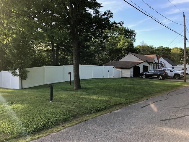 exterior space featuring a front lawn and fence