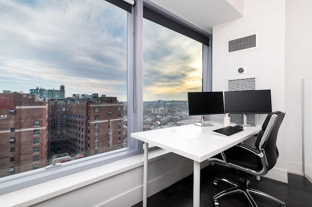 home office featuring a view of city, baseboards, and wood finished floors