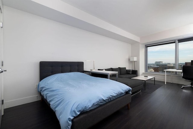 bedroom with wood finished floors and baseboards