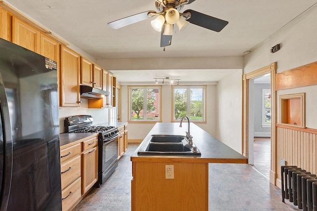 128 7th St, Montague, MA 01376 - kitchen featuring black appliances, under cabinet range hood, a sink, a kitchen island with sink, and a ceiling fan