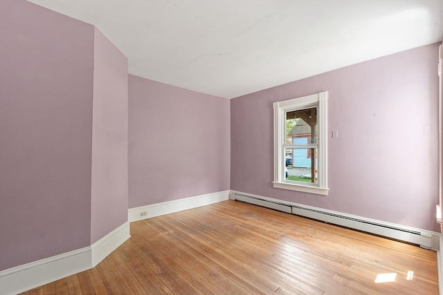 128 7th St, Montague, MA 01376 - spare room with baseboard heating, hardwood / wood-style floors, and baseboards