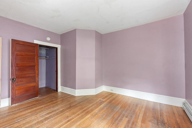 128 7th St, Montague, MA 01376 - unfurnished room with baseboards, wood finished floors, a baseboard radiator, and a smoke detector