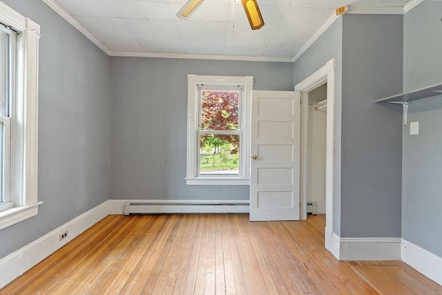 128 7th St, Montague, MA 01376 - spare room featuring a ceiling fan, a baseboard heating unit, light wood-style floors, crown molding, and baseboards