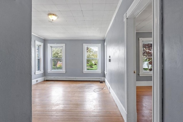128 7th St, Montague, MA 01376 - unfurnished room with baseboard heating, ornamental molding, hardwood / wood-style flooring, a textured wall, and baseboards