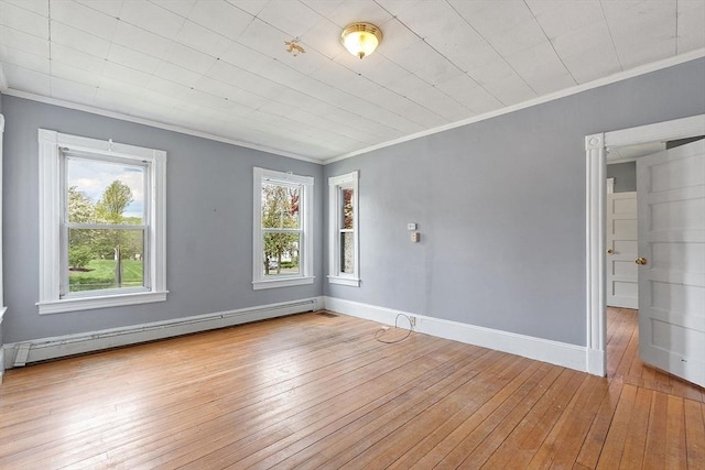 128 7th St, Montague, MA 01376 - empty room with baseboard heating, crown molding, hardwood / wood-style flooring, and baseboards