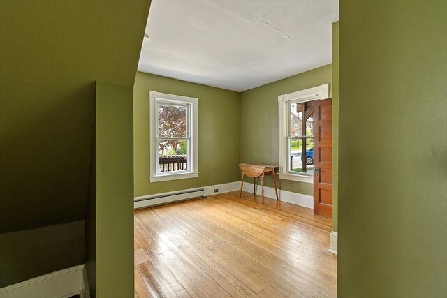 128 7th St, Montague, MA 01376 - spare room with baseboard heating, light wood-type flooring, and baseboards