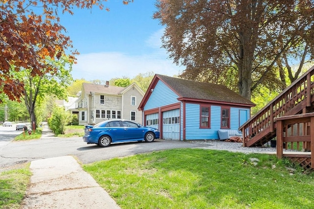 128 7th St, Montague, MA 01376 - view of side of property featuring stairs, an outbuilding, and a yard