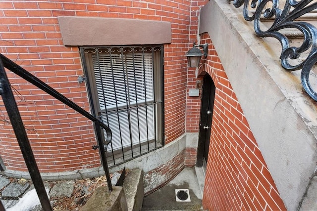 property entrance with brick siding