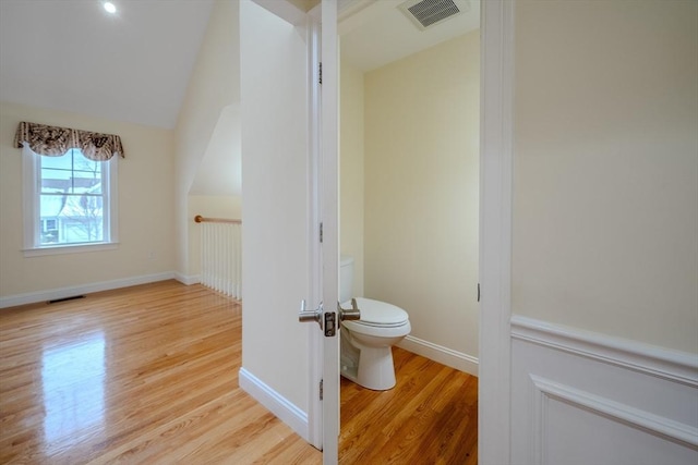 bathroom with visible vents, toilet, and wood finished floors