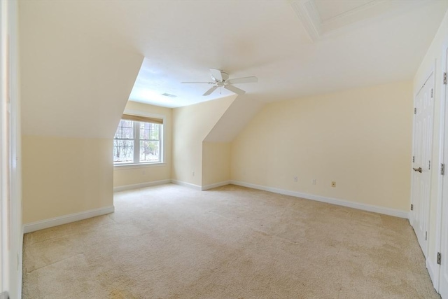 bonus room with light carpet, ceiling fan, baseboards, and vaulted ceiling