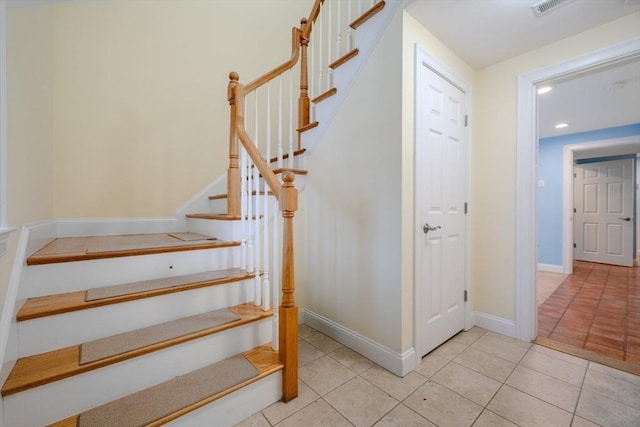 stairway featuring recessed lighting, baseboards, and tile patterned floors