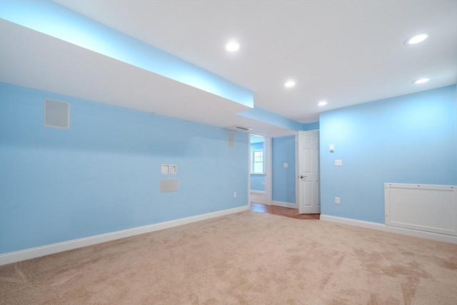 unfurnished room featuring recessed lighting, light colored carpet, and baseboards