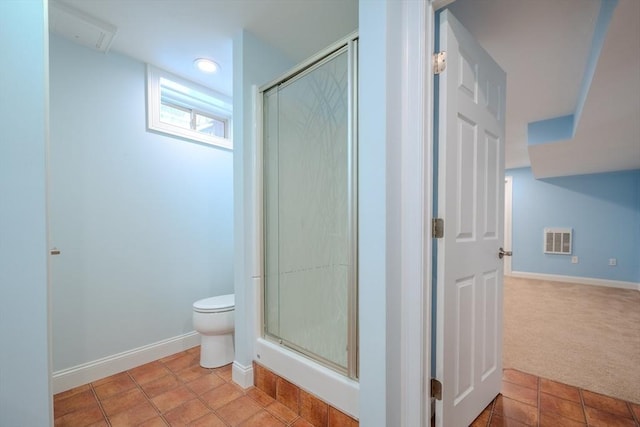 full bathroom featuring toilet, a shower stall, visible vents, and tile patterned floors