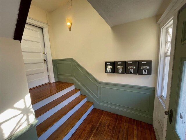 34 Channing St Unit C, Newton, MA 02458 - staircase with wood finished floors, a decorative wall, plenty of natural light, and a wainscoted wall