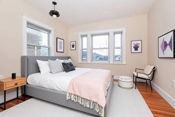 34 Channing St Unit C, Newton, MA 02458 - bedroom featuring multiple windows, baseboards, and wood finished floors