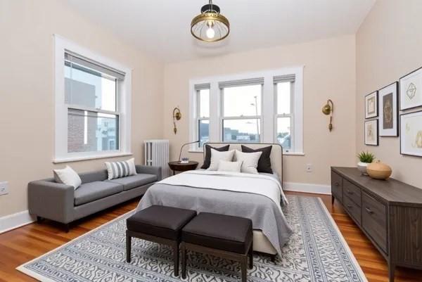 34 Channing St Unit C, Newton, MA 02458 - bedroom featuring radiator heating unit, baseboards, and wood finished floors