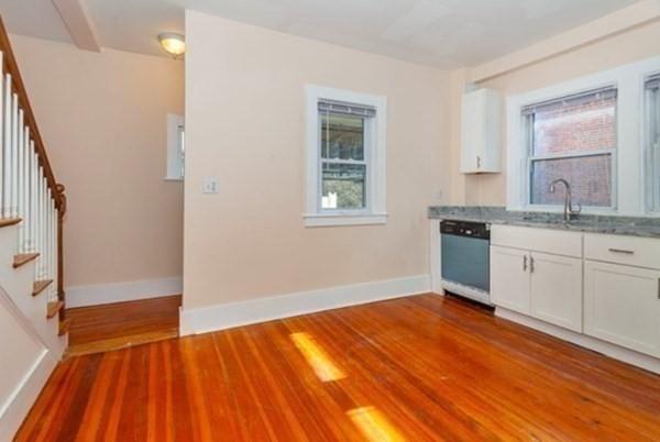 34 Channing St Unit C, Newton, MA 02458 - kitchen with white cabinets, dishwasher, a healthy amount of sunlight, and wood finished floors