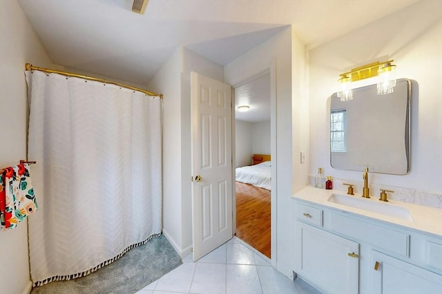 ensuite bathroom featuring a shower with curtain, connected bathroom, vanity, and tile patterned floors