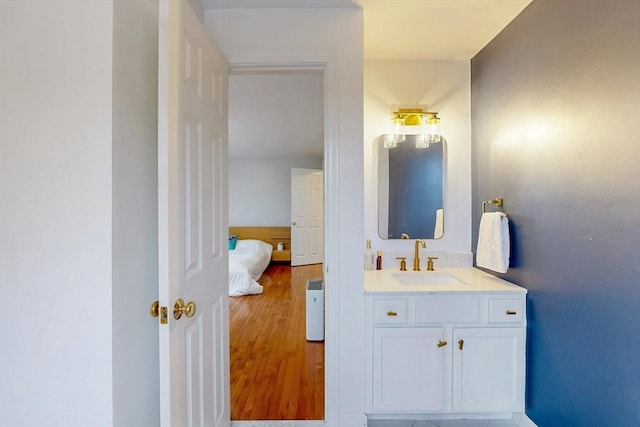 bathroom with wood finished floors and vanity