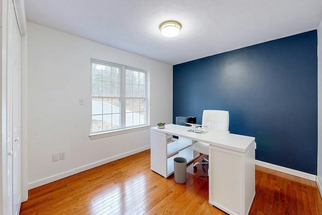 home office featuring light wood-type flooring and baseboards