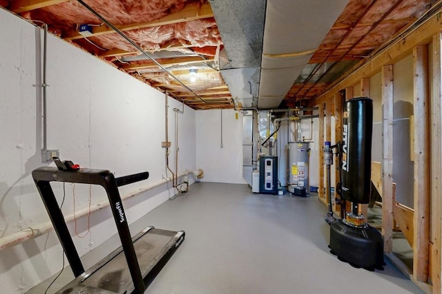 unfinished basement featuring gas water heater and heating unit