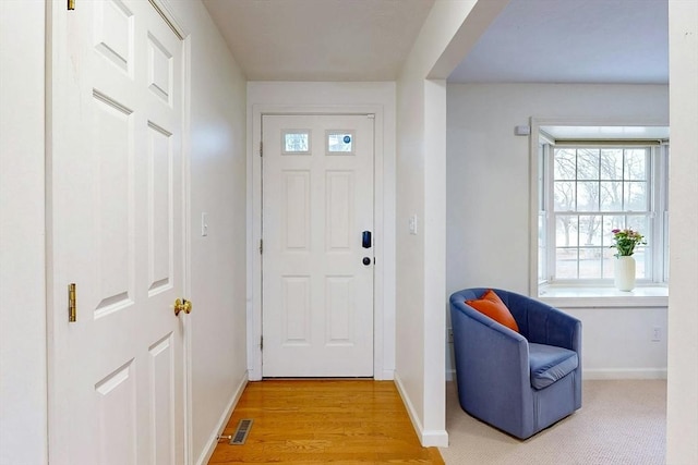 entrance foyer with light wood-style flooring, visible vents, and baseboards