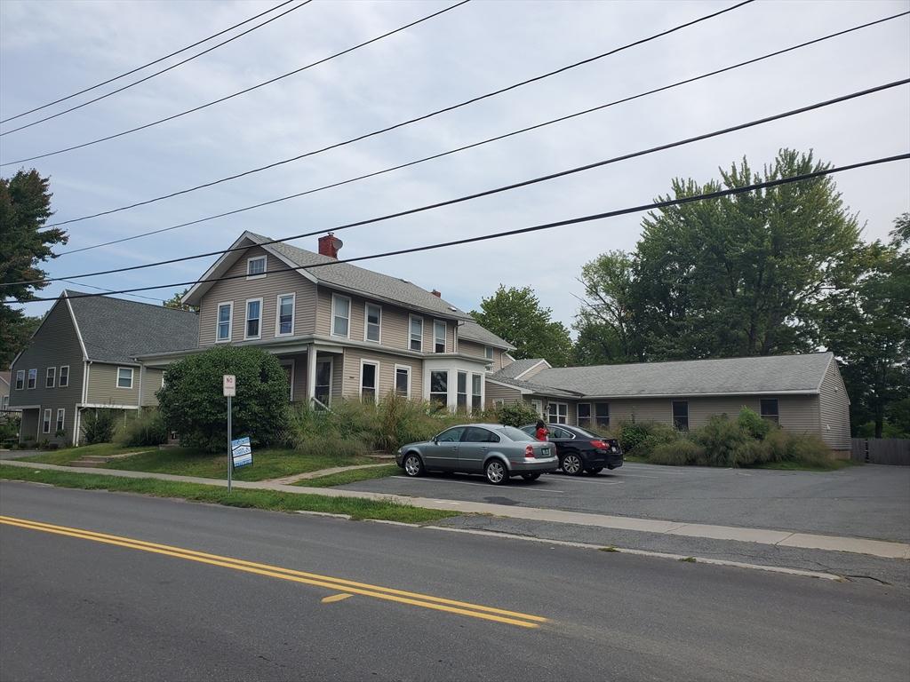 107-109 Conway St, Greenfield, MA 01301 - view of front of house featuring uncovered parking and a chimney
