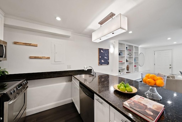 kitchen featuring dark wood finished floors, dark stone counters, appliances with stainless steel finishes, white cabinets, and a sink