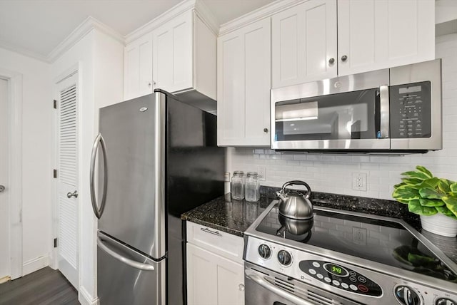 kitchen with tasteful backsplash, appliances with stainless steel finishes, crown molding, and white cabinetry