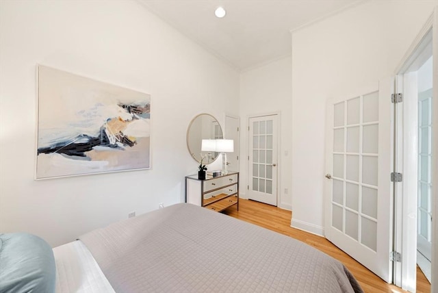 bedroom featuring recessed lighting, french doors, and wood finished floors