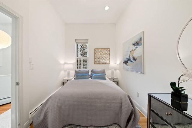 bedroom with recessed lighting, baseboards, and wood finished floors