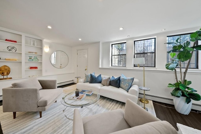 living area with recessed lighting, wood finished floors, and a baseboard radiator