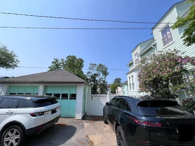 view of home's exterior with a garage and an outbuilding