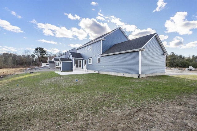 rear view of property with a yard