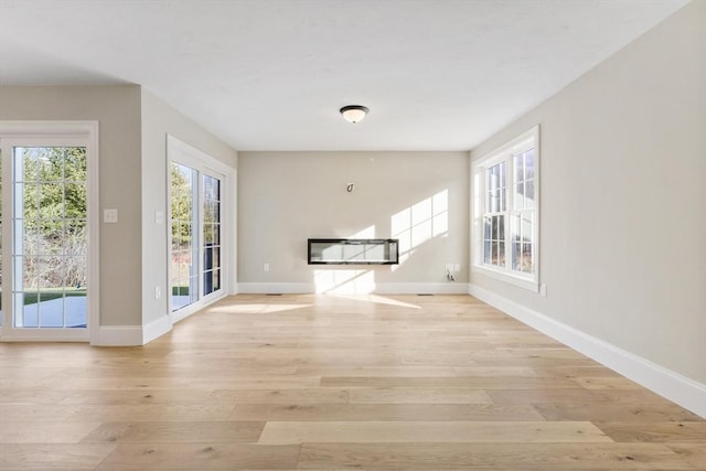 unfurnished living room featuring light hardwood / wood-style flooring