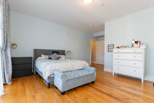 bedroom featuring baseboards and light wood-style flooring