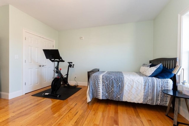 bedroom with wood finished floors and baseboards