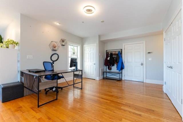 office space featuring light wood-style flooring and baseboards