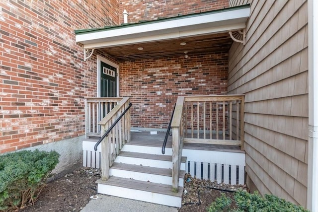 view of exterior entry featuring brick siding