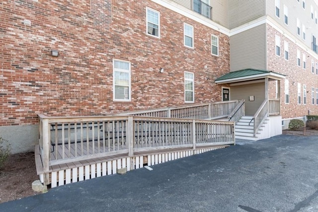 exterior space featuring brick siding and a deck