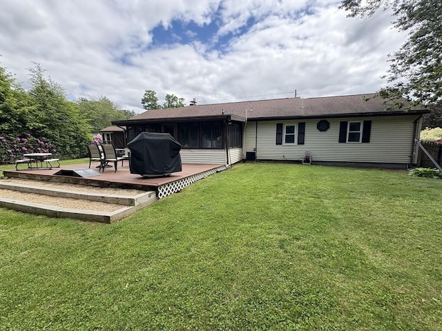 34 Pinecrest Rd, West Bridgewater, MA 02379 - back of property featuring a wooden deck, a lawn, a sunroom, central air condition unit, and a shingled roof