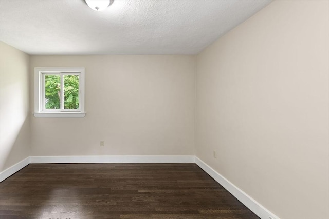 46 Blackmer, Sudbury, MA 01776 - empty room featuring dark wood-style floors, baseboards, and a textured ceiling