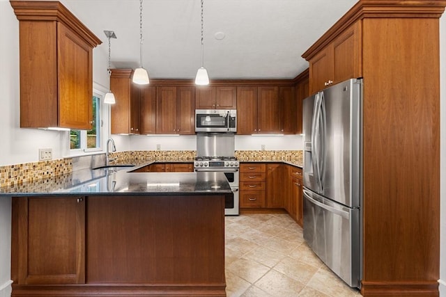 46 Blackmer, Sudbury, MA 01776 - kitchen featuring appliances with stainless steel finishes, a sink, a peninsula, dark stone counters, and decorative light fixtures
