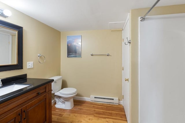 46 Blackmer, Sudbury, MA 01776 - bathroom with a baseboard radiator, wood finished floors, vanity, toilet, and a shower