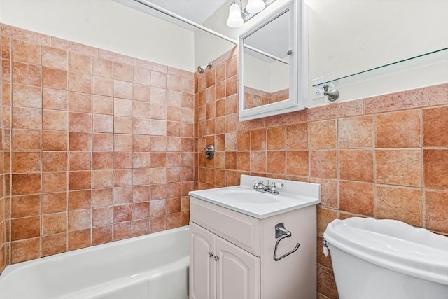 bathroom featuring vanity, tile walls,  shower combination, and toilet