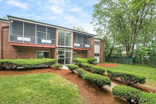 125 Grove St Unit 7, Boston, MA 02132 - back of property featuring a sunroom and brick siding