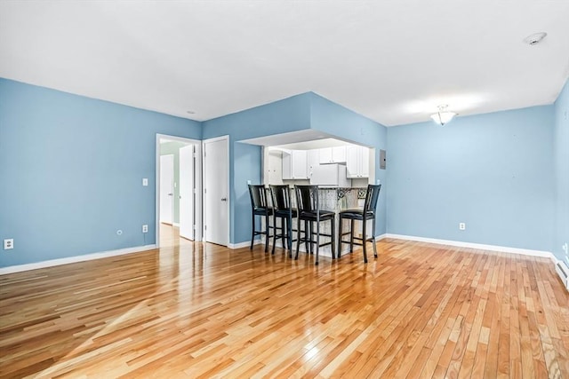 interior space with light wood-type flooring and baseboards