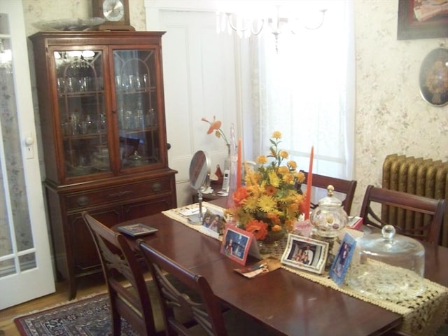 dining area featuring radiator and hardwood / wood-style floors