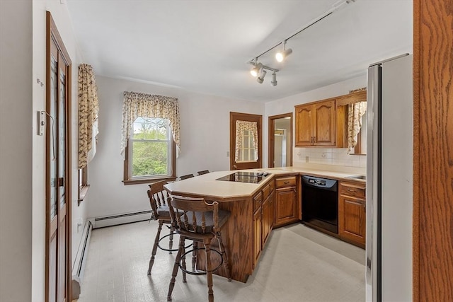 74 W Main St, Westminster, MA 01473 - kitchen with black appliances, a peninsula, a baseboard radiator, and brown cabinetry