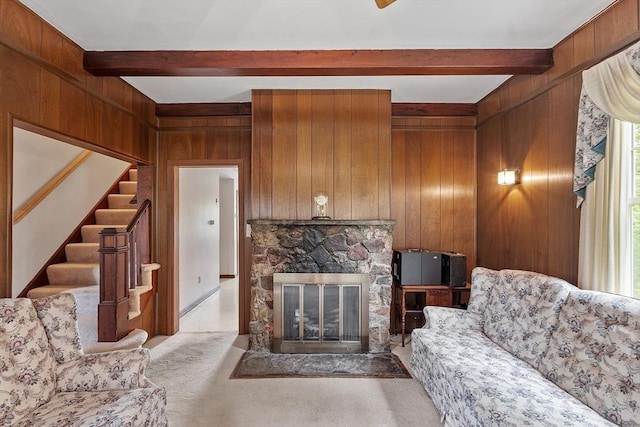 74 W Main St, Westminster, MA 01473 - carpeted living area featuring beamed ceiling, healthy amount of natural light, wooden walls, stairs, and a fireplace
